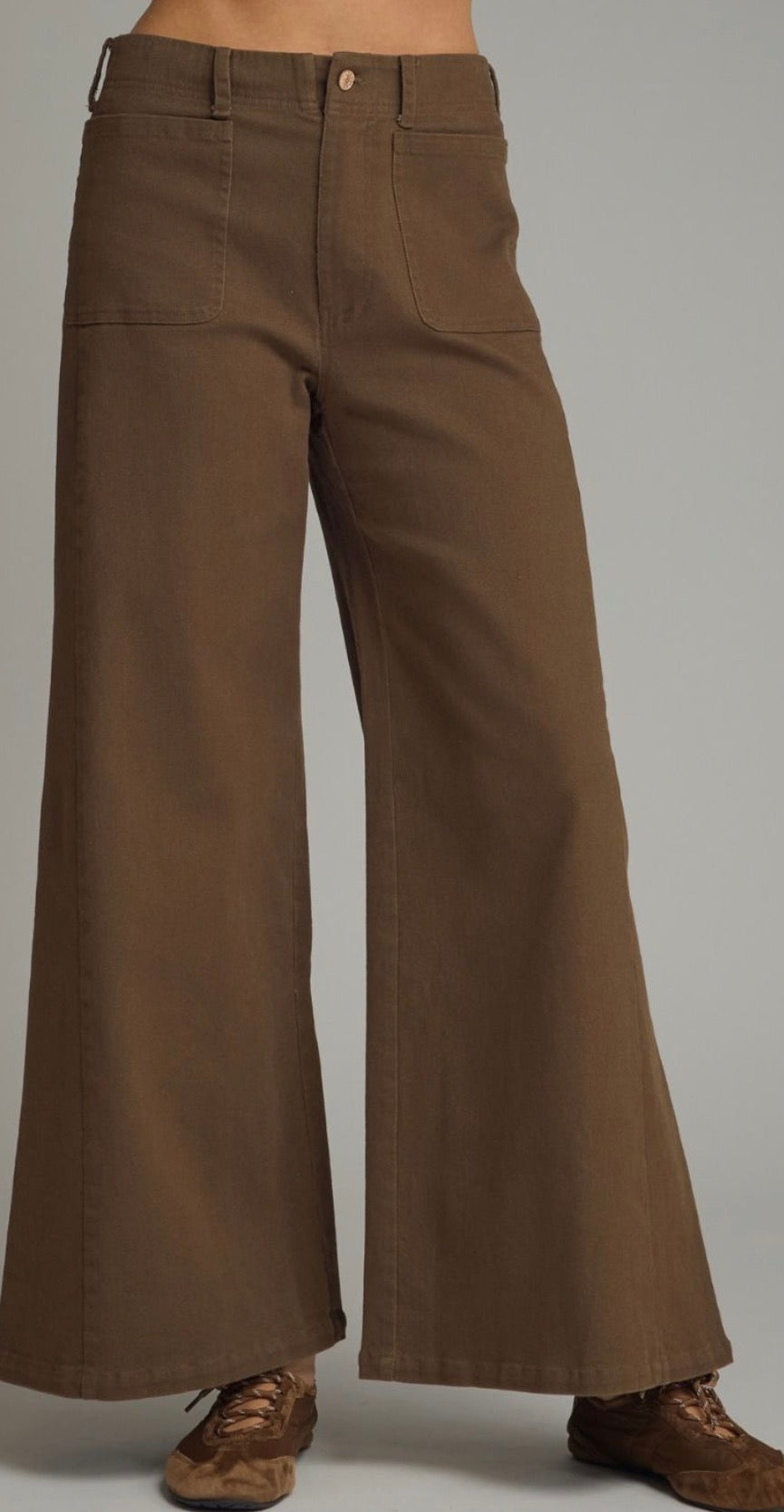 Entro Solid knit wide leg pants featuring front pockets. Zip-fly button front closure. Front and back pockets. Unlined. Woven. Non-sheer. Lightweight.