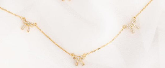 Michelle McDowell Holiday Bow Necklaces Clear