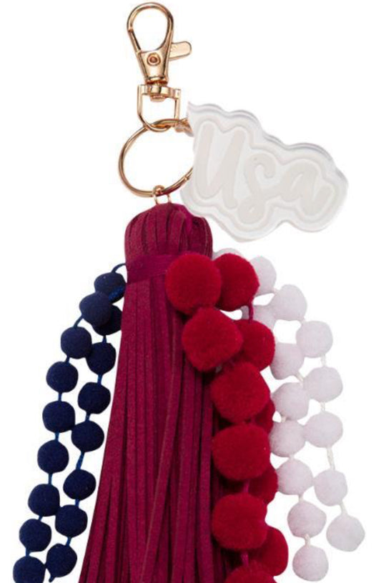 Jane Marie White, Red, Blue Poms With Red Tassel & White Acylic “USA” Charm Keychain