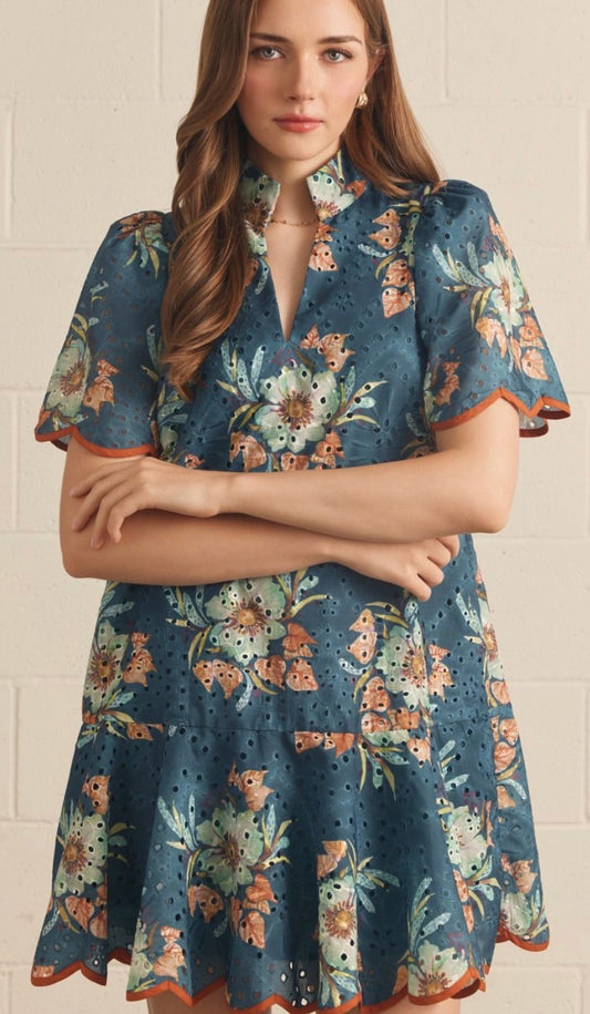 Entro Floral eyelet short puff sleeve mini dress featuring scallop trim. Stand collar V-neck. Ruffle hem. Side pockets. Lined. Woven. Non-sheer. Lightweight.